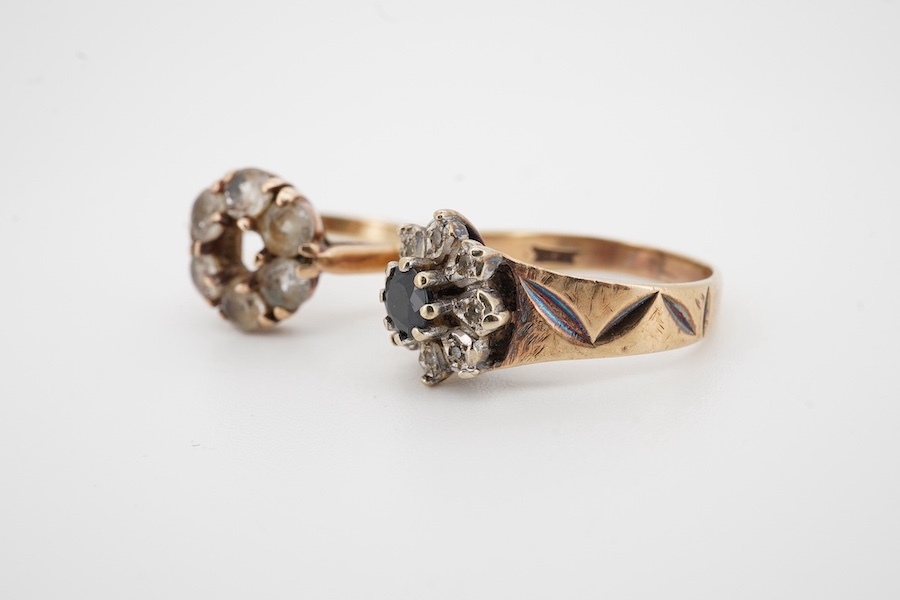 A modern 9ct gold, sapphire and diamond chip set flower head cluster ring and one other 9ct gold ring set with colourless stones (one missing), gross weight 6.6 grams. Condition - poor to fair